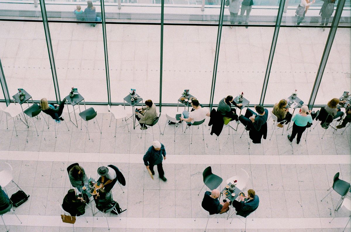 people sitting on chairs near tables during daytime